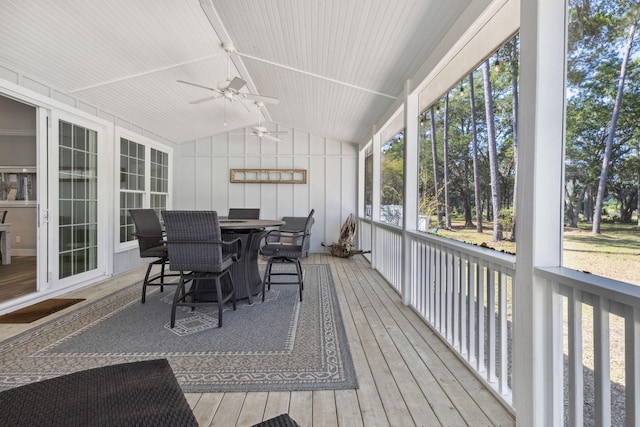 sunroom / solarium featuring ceiling fan, lofted ceiling, and a wealth of natural light