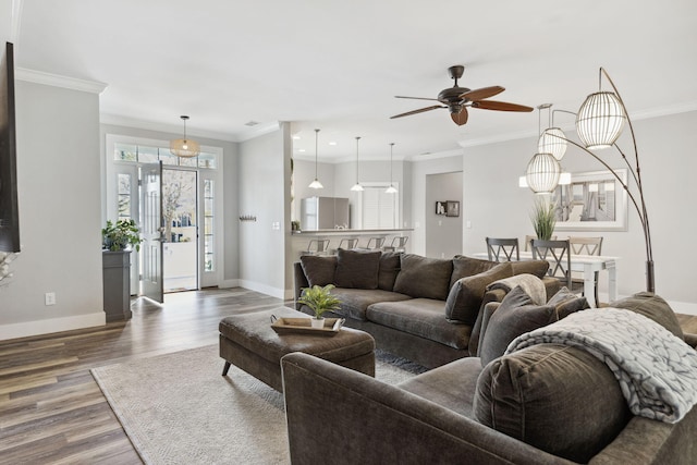 living room featuring ceiling fan, crown molding, and dark hardwood / wood-style flooring