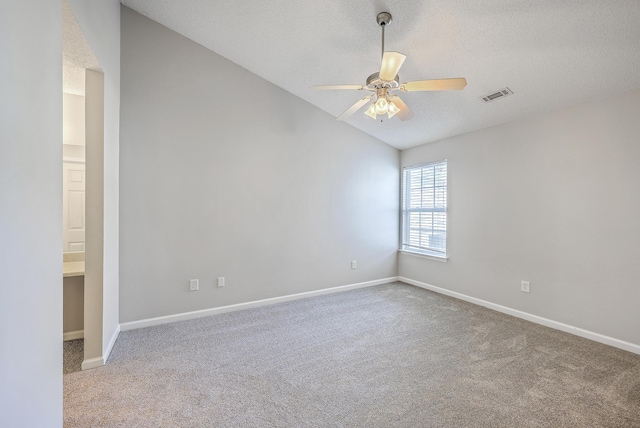8028 Vermont Rd, North Charleston, SC 29418 - carpeted empty room featuring lofted ceiling, a ceiling fan, baseboards, and a textured ceiling
