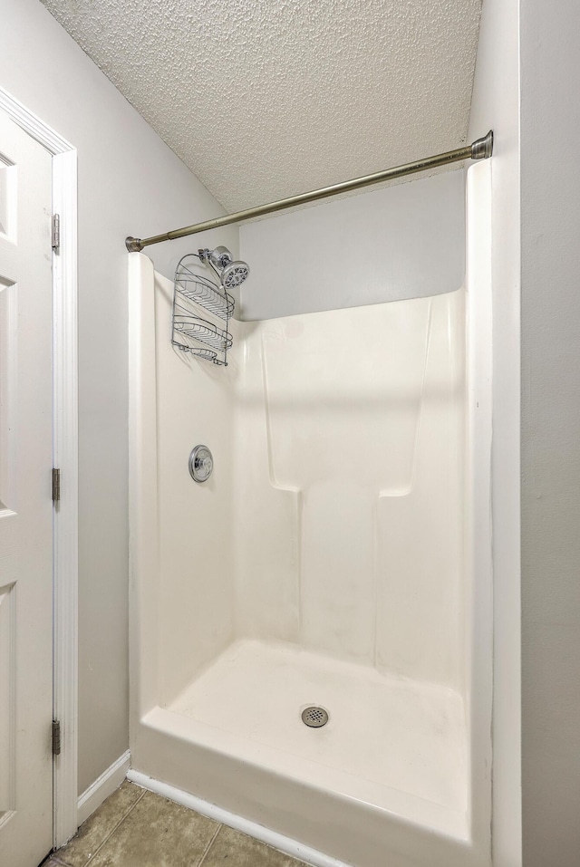 8028 Vermont Rd, North Charleston, SC 29418 - full bathroom featuring a textured ceiling, tile patterned flooring, a shower, and baseboards