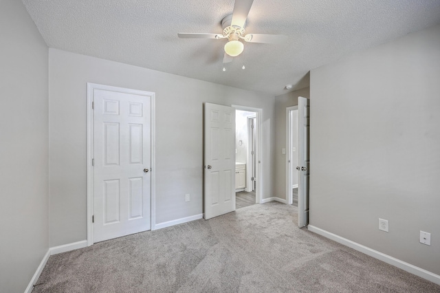 8028 Vermont Rd, North Charleston, SC 29418 - unfurnished bedroom featuring carpet floors, a textured ceiling, baseboards, connected bathroom, and ceiling fan