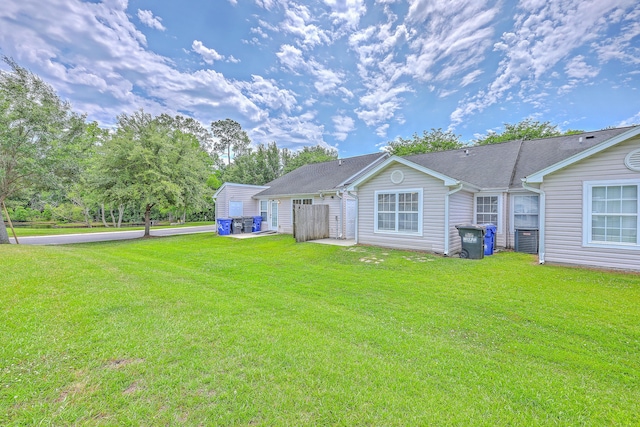8028 Vermont Rd, North Charleston, SC 29418 - back of house featuring a yard and central air condition unit
