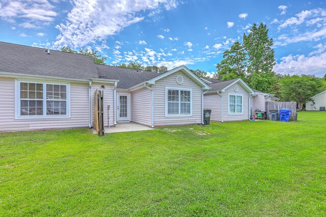8028 Vermont Rd, North Charleston, SC 29418 - back of house featuring a lawn and a patio area