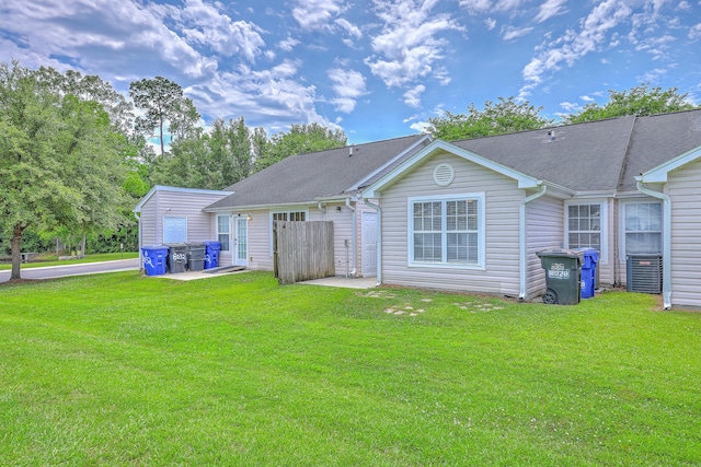 8028 Vermont Rd, North Charleston, SC 29418 - back of house with a lawn, a shingled roof, and a patio