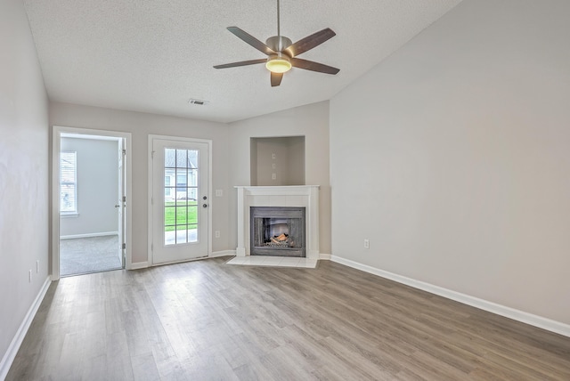 8028 Vermont Rd, North Charleston, SC 29418 - unfurnished living room featuring wood finished floors, ceiling fan, a textured ceiling, a fireplace with flush hearth, and baseboards