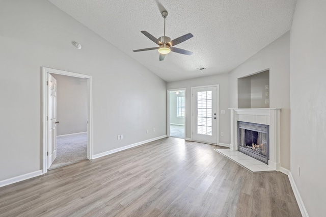 8028 Vermont Rd, North Charleston, SC 29418 - unfurnished living room with a textured ceiling, vaulted ceiling, wood finished floors, a ceiling fan, and a tiled fireplace