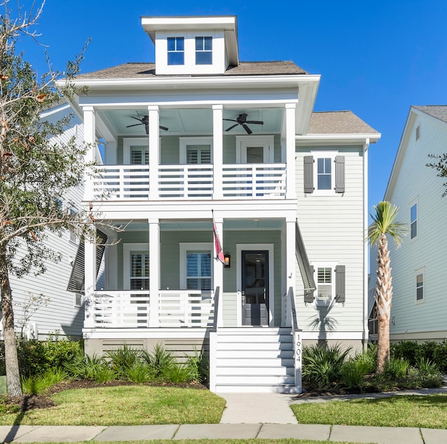 view of front of house with ceiling fan, a porch, and a balcony