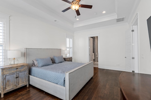 bedroom with dark hardwood / wood-style floors, a raised ceiling, ceiling fan, and ornamental molding