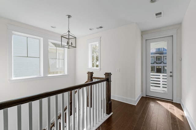 interior space featuring dark hardwood / wood-style flooring and a notable chandelier