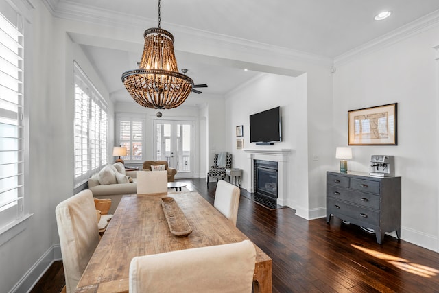 dining room featuring crown molding, dark hardwood / wood-style flooring, a chandelier, and french doors