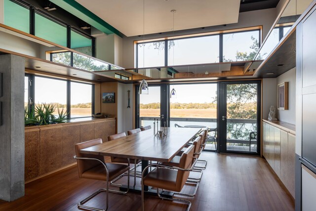 905 Palm Blvd, Isle Of Palms, SC 29451 - dining area with dark wood finished floors, healthy amount of natural light, and a towering ceiling