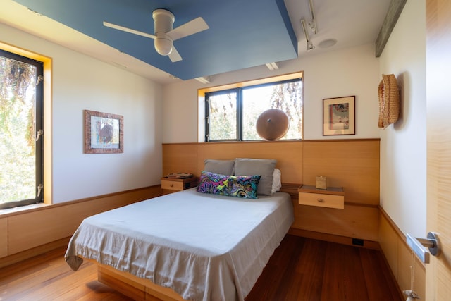 905 Palm Blvd, Isle Of Palms, SC 29451 - bedroom featuring rail lighting, wood finished floors, a ceiling fan, and a wainscoted wall