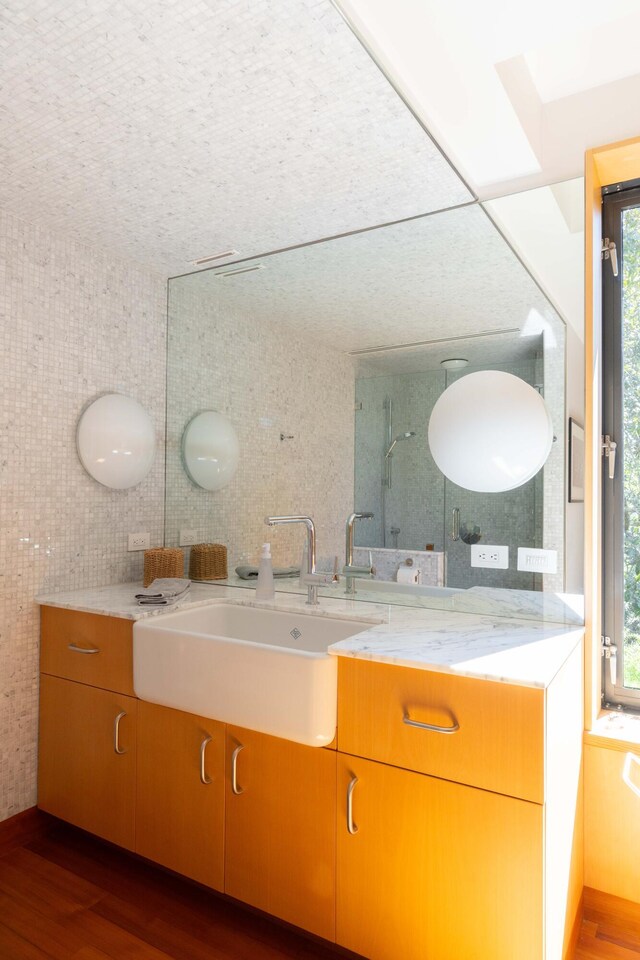 905 Palm Blvd, Isle Of Palms, SC 29451 - full bath featuring wood finished floors, healthy amount of natural light, vanity, and tile walls