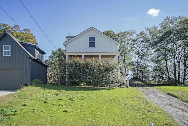 view of front of home with a garage and a front lawn