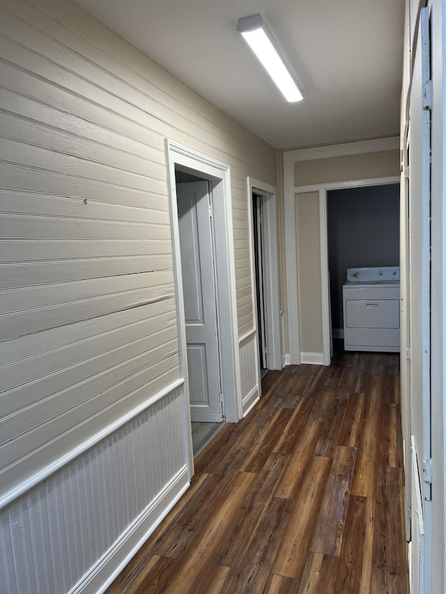 hall featuring dark hardwood / wood-style flooring and washer / dryer