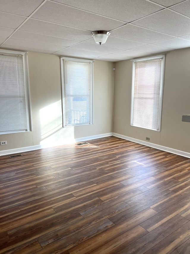 spare room with plenty of natural light and dark hardwood / wood-style floors