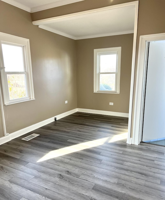 unfurnished room featuring ornamental molding and wood-type flooring