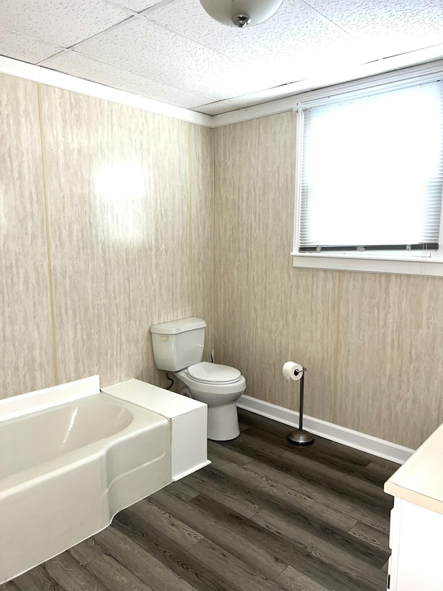 bathroom featuring hardwood / wood-style flooring, vanity, toilet, and a bathtub