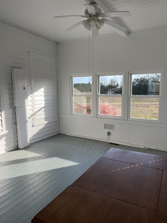 interior space with ceiling fan and electric panel