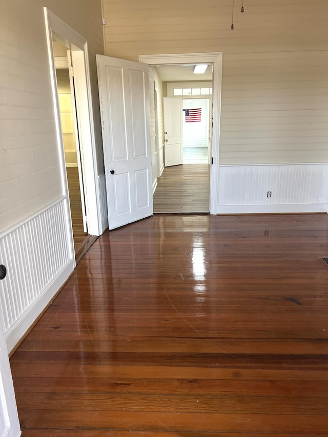 unfurnished room with dark hardwood / wood-style floors