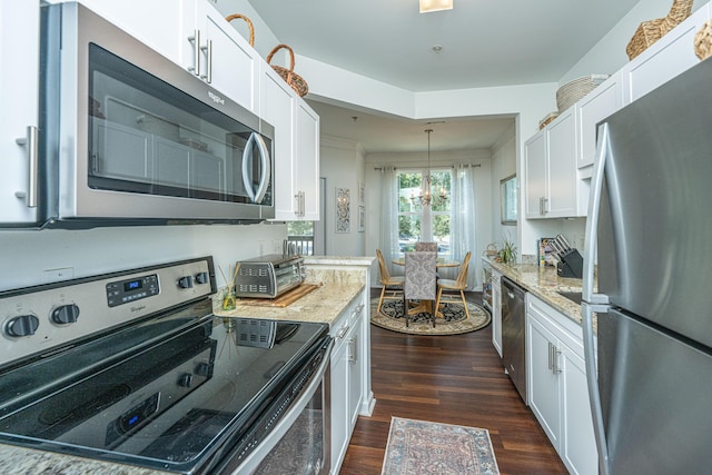 kitchen featuring appliances with stainless steel finishes, white cabinetry, and dark wood finished floors