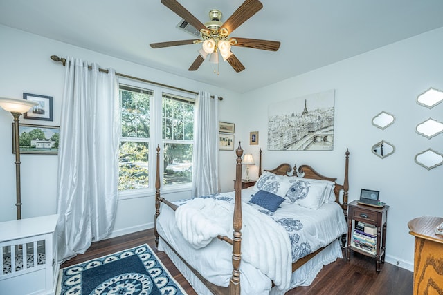 bedroom with wood finished floors, baseboards, and a ceiling fan
