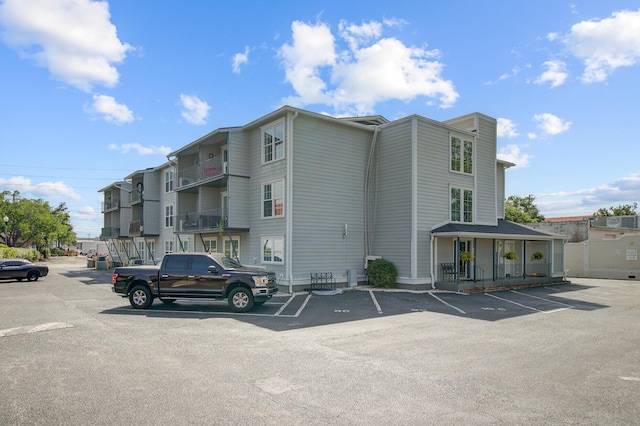 view of building exterior with uncovered parking