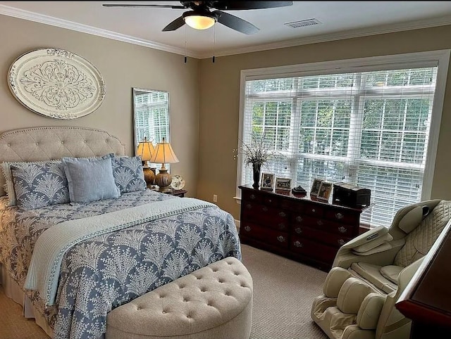 carpeted bedroom featuring ceiling fan and crown molding