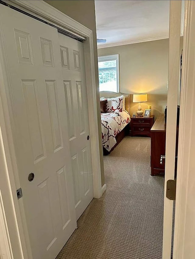 bedroom with light colored carpet and ornamental molding