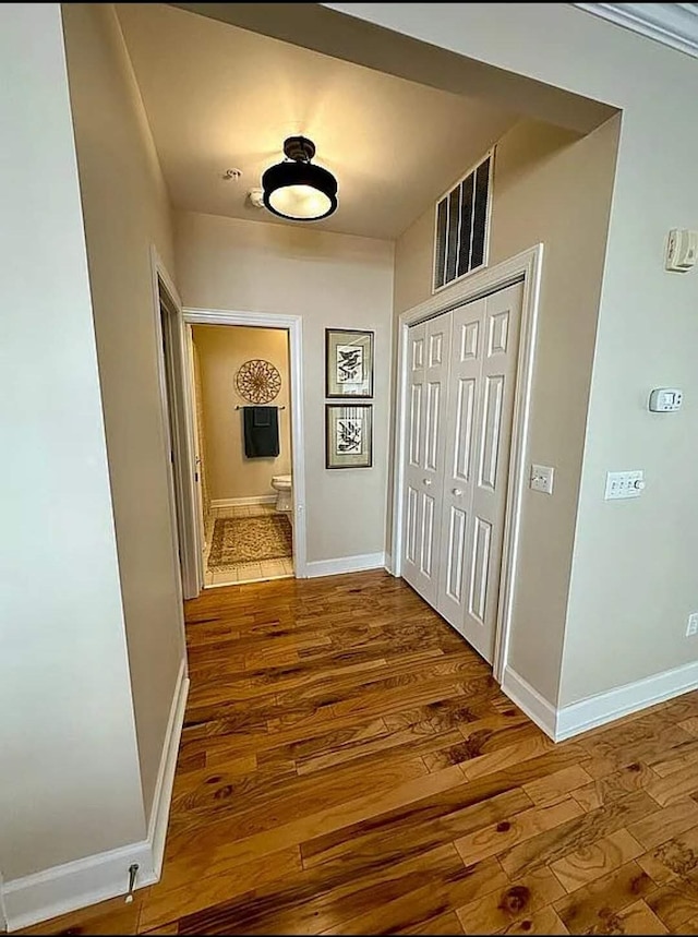 corridor with wood-type flooring