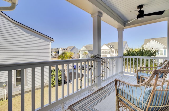 balcony with a residential view and ceiling fan