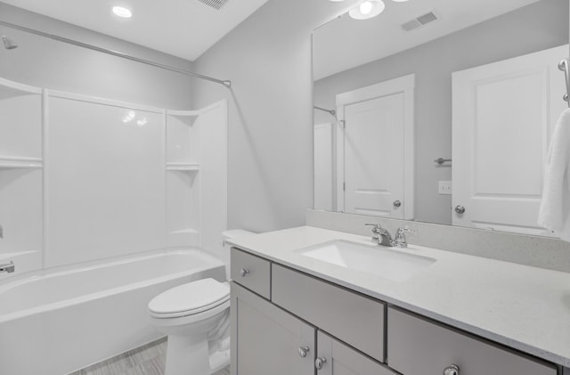 bathroom featuring visible vents, toilet, vanity, and washtub / shower combination