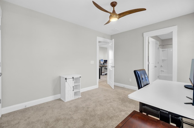 home office featuring baseboards, a ceiling fan, and carpet floors