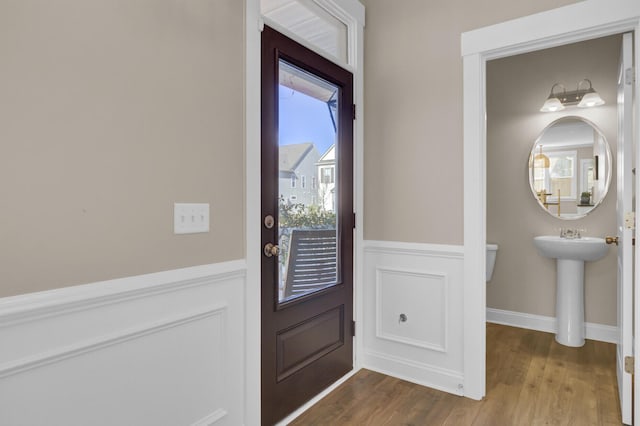 entrance foyer with baseboards and wood finished floors