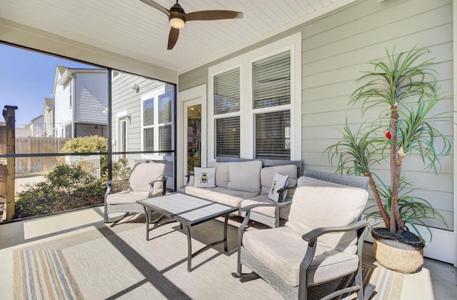 sunroom / solarium featuring a ceiling fan