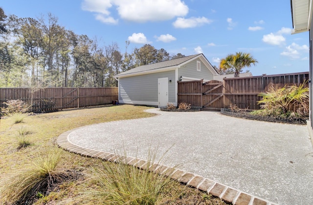 view of yard featuring a patio, a gate, and fence