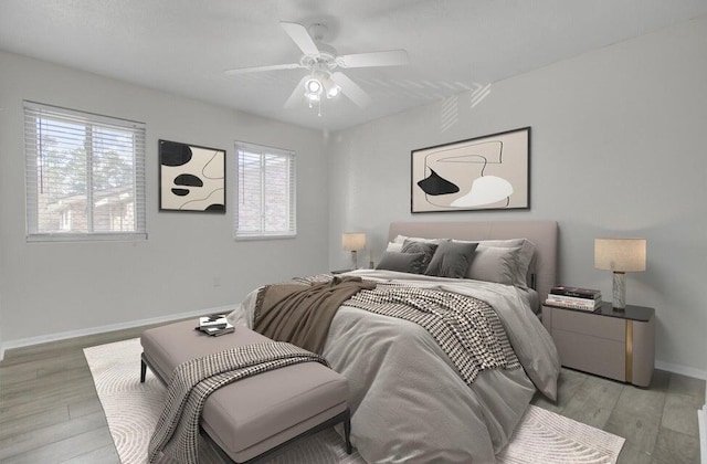 bedroom featuring light wood-style floors, baseboards, and a ceiling fan