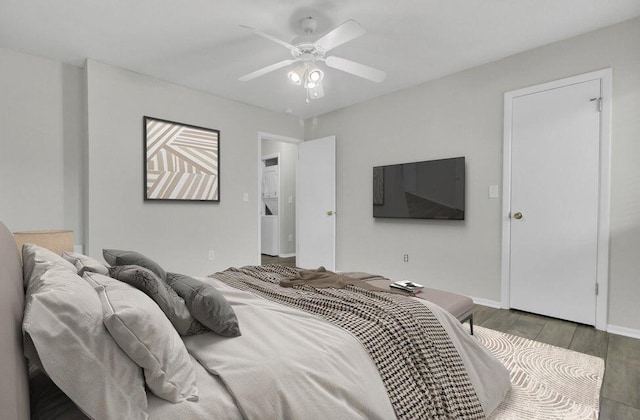 bedroom with a ceiling fan, baseboards, and wood finished floors