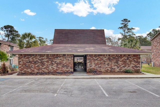 view of building exterior with uncovered parking