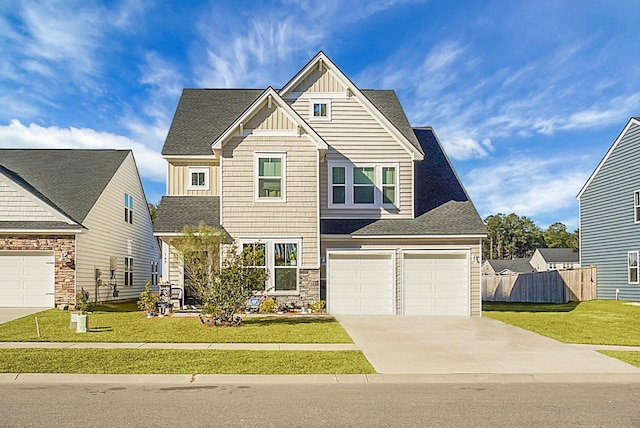 craftsman inspired home featuring a garage and a front yard