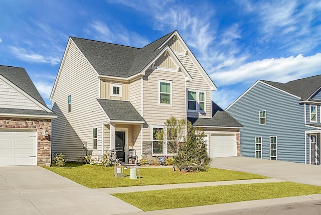 view of front of property featuring a garage and a front yard