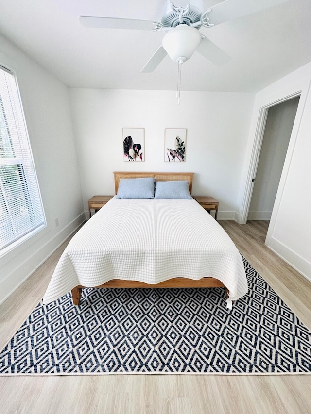 bedroom with hardwood / wood-style floors and ceiling fan