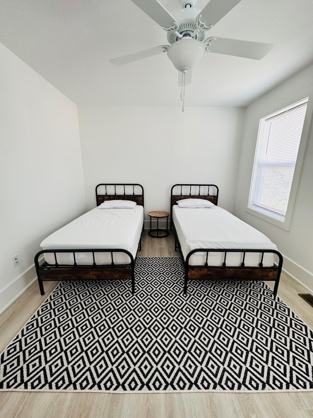 bedroom featuring hardwood / wood-style floors and ceiling fan