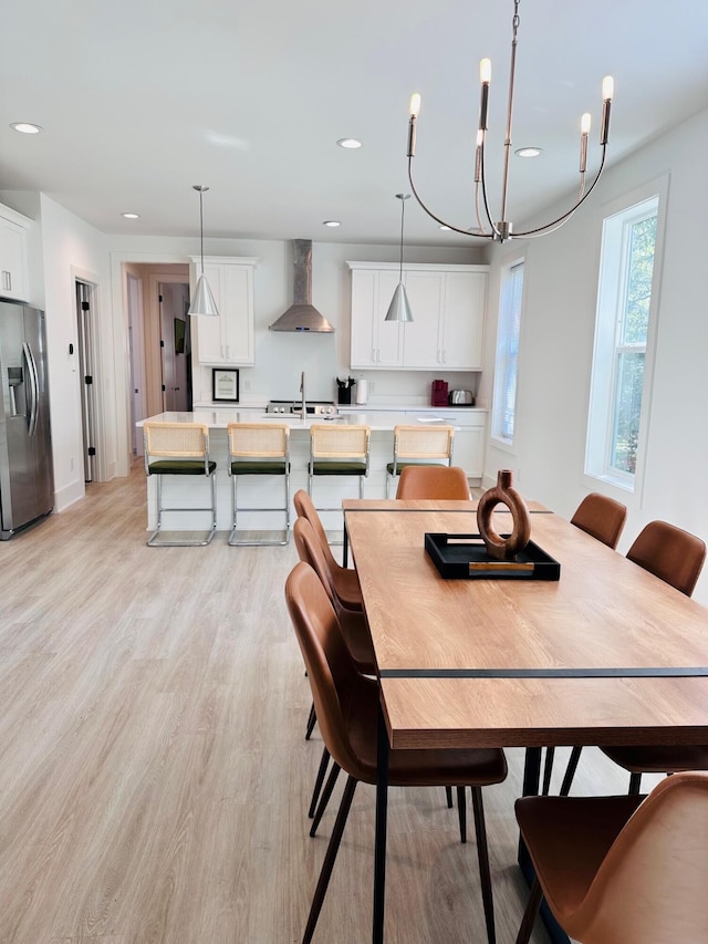 dining area with sink and light hardwood / wood-style flooring