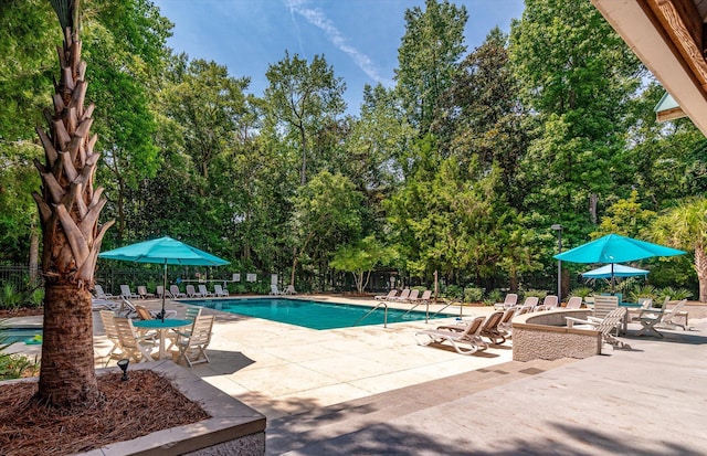 5152 Coral Reef Dr, Johns Island, SC 29455 - community pool with a patio and view of scattered trees