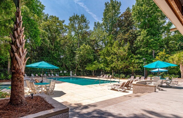 5152 Coral Reef Dr, Johns Island, SC 29455 - community pool with a patio and view of scattered trees