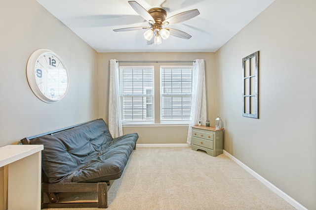 sitting room with carpet, ceiling fan, and baseboards