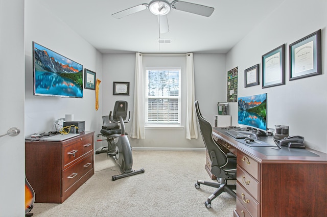 carpeted home office featuring visible vents, a ceiling fan, and baseboards