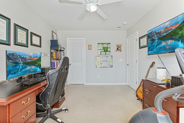 home office featuring visible vents, baseboards, a ceiling fan, and light colored carpet