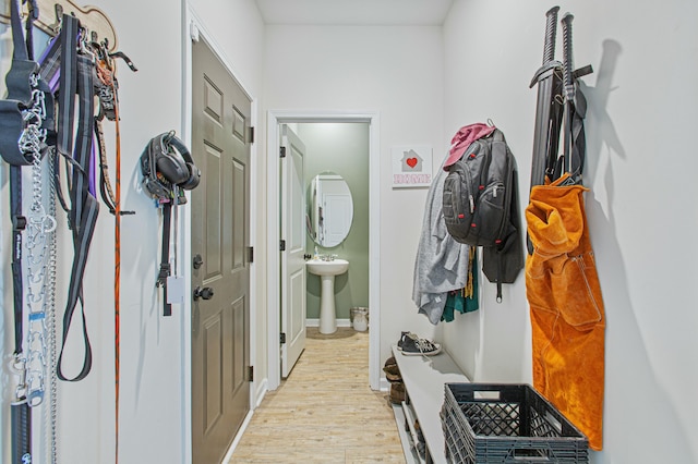 mudroom featuring light wood-style flooring and baseboards